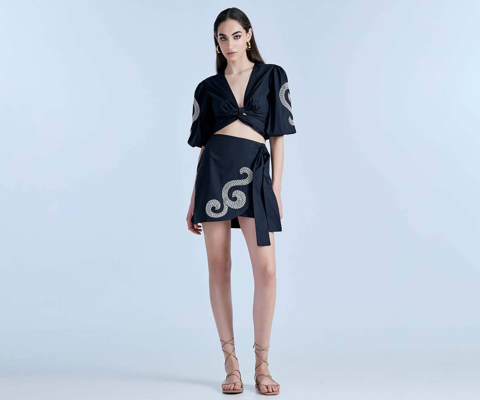 Black cotton mini wrap skirt with white embroideries in London, UK