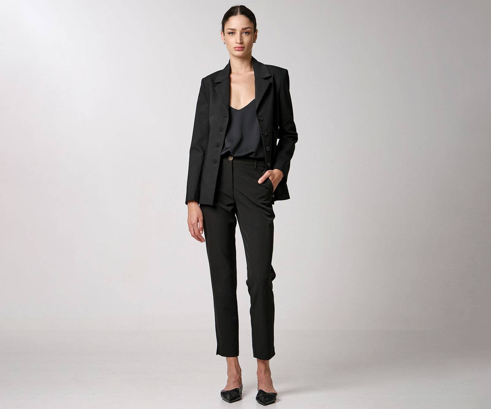 Straight-leg pants with slits at the hemlines and monogram buttons in black in Copenhagen, Denmark