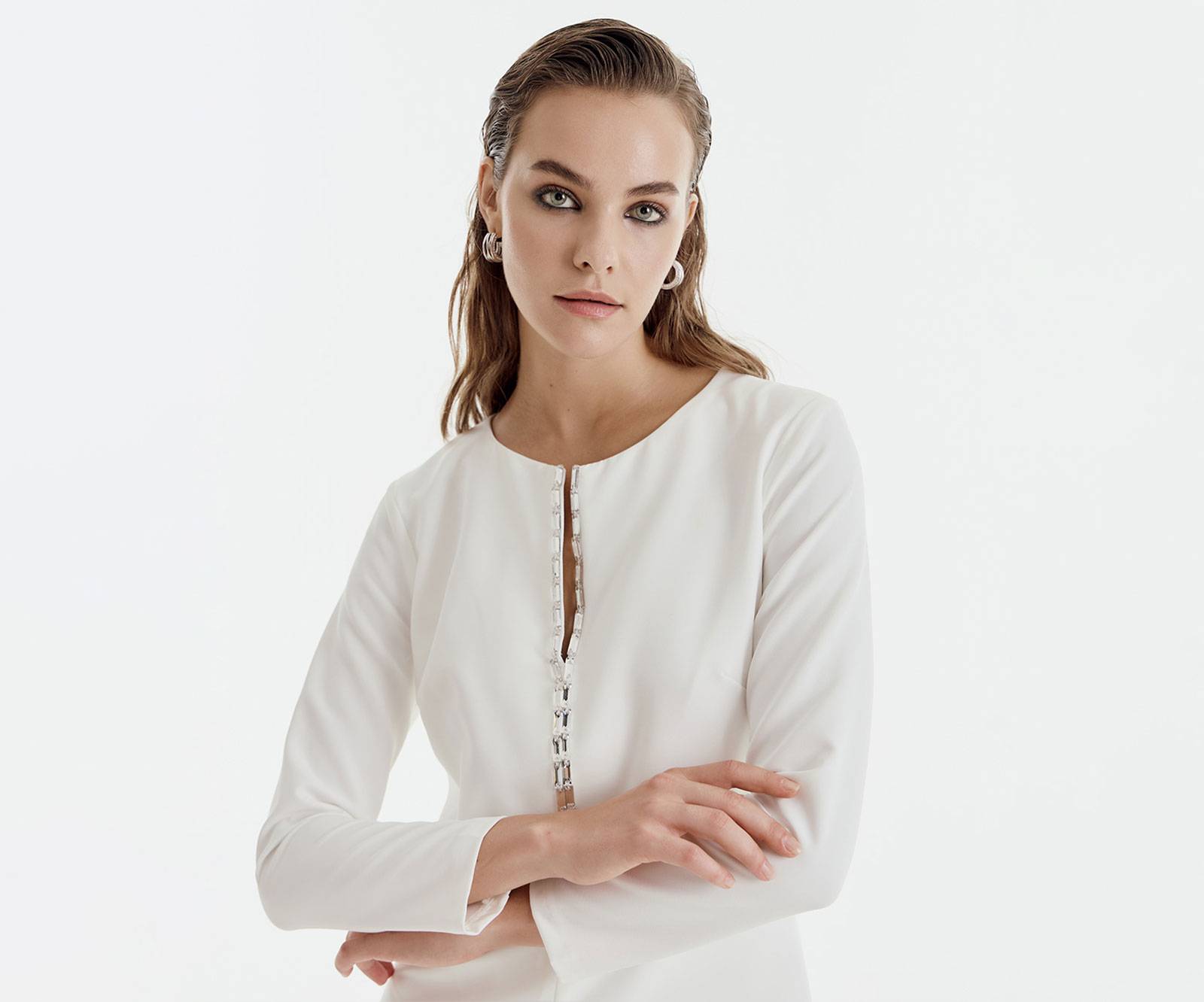 Mini dress with long sleeves and a V neckline, which is embellished with rhinestones, in off-white in Cardiff, Wales