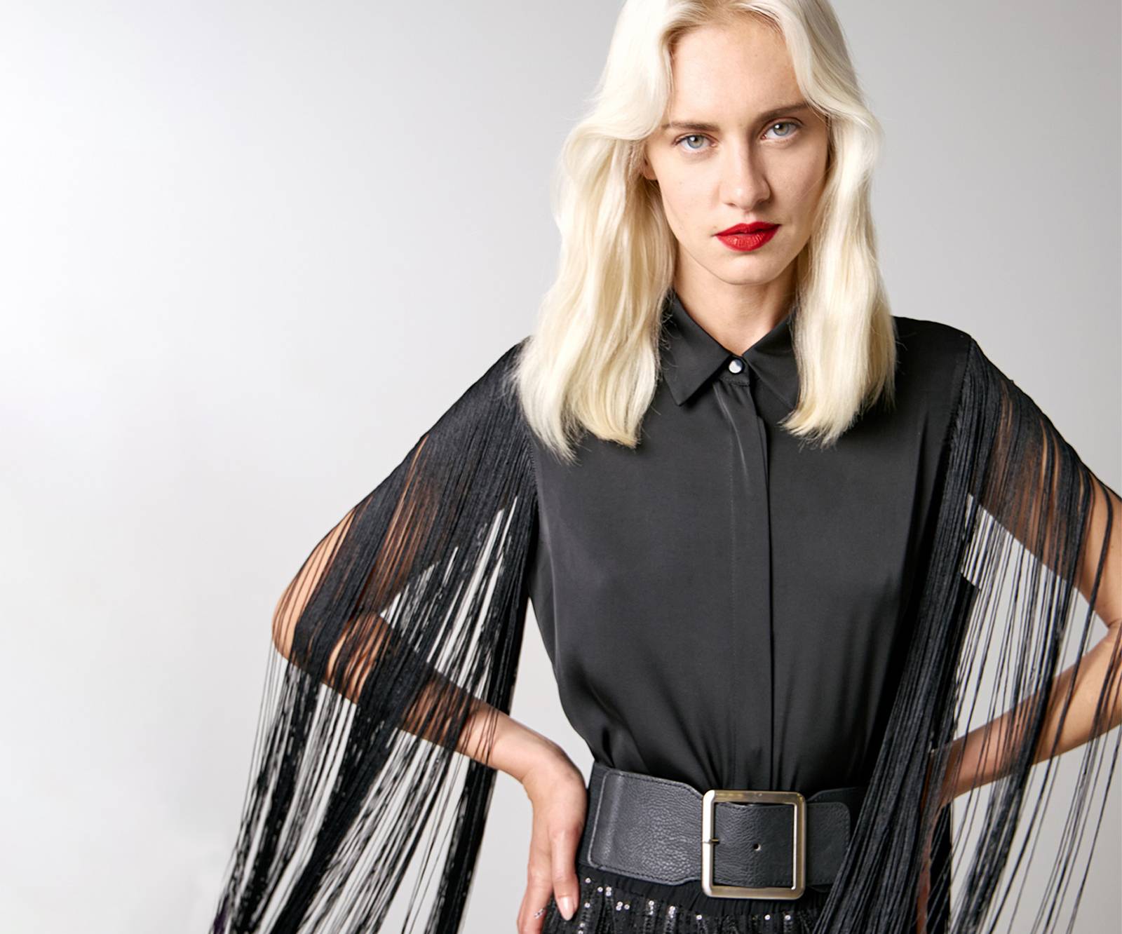 Sleeveless, button up shirt with fringes on the sleeves in black in Copenhagen, Denmark